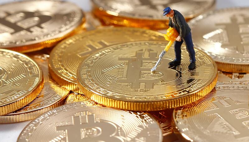 A small toy figure is seen on representations of the Bitcoin virtual currency in this illustration picture, December 26, 2017. REUTERS/Dado Ruvic/Illustration