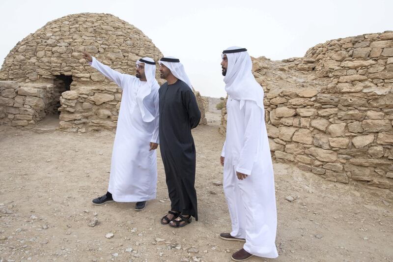 AL AIN, UNITED ARAB EMIRATES - January 19, 2019: HH Sheikh Mohamed bin Zayed Al Nahyan, Crown Prince of Abu Dhabi and Deputy Supreme Commander of the UAE Armed Forces (C) inspects Jebel Hafeet tombs. Seen with HE Mohamed Khalifa Al Mubarak, Chairman of the Department of Culture and Tourism and Abu Dhabi Executive Council Member (L) and HE Saif Ghobash, Director General of Abu Dhabi Tourism and Culture Authority (R).

( Mohammed Al Blooshi )
---