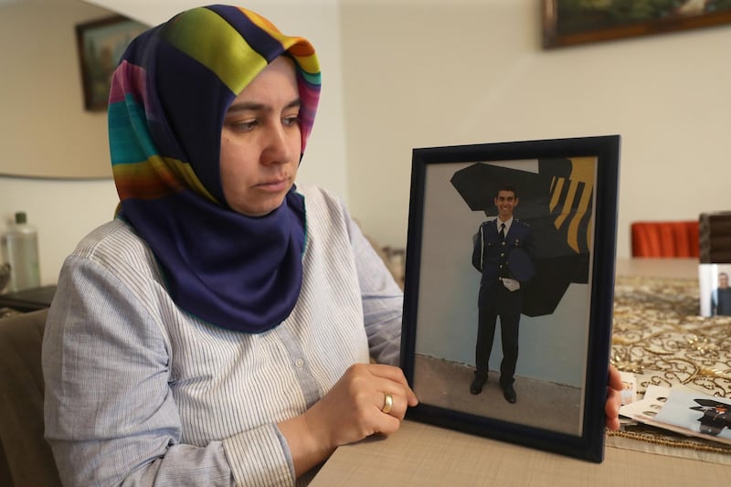 Melek Cetinkaya holding a photo of her son who has been in prison for over three years, during an interview with AFP at her home in the Turkish capital, Ankara.  AFP