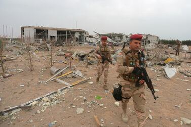 Iraqi army soldiers inspect the destruction at an airport complex under construction in Karbala, Iraq. AP