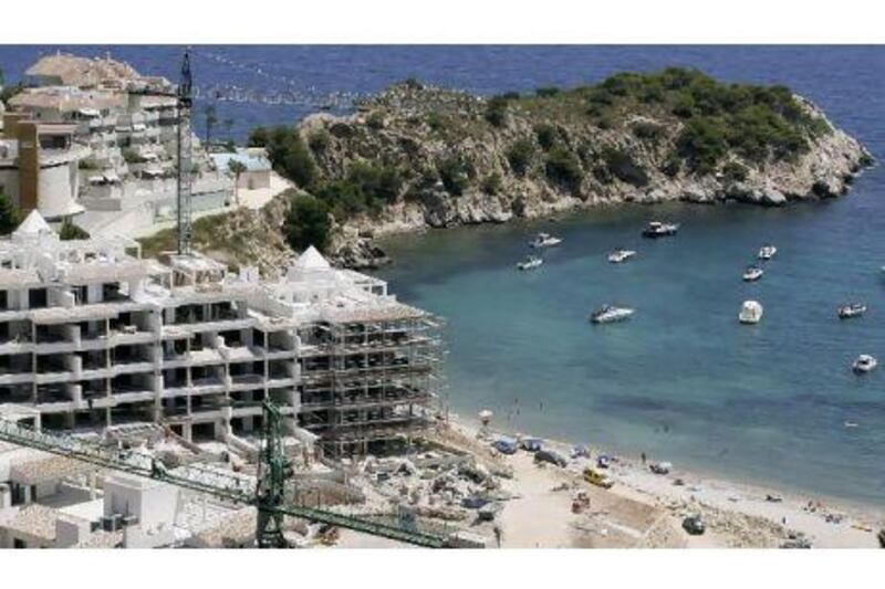 Britons and Germans are shying away from buying properties in Spain although prices have fallen by half in some coastal areas. Above, new holiday homes being built in Altea on the country's Costa del Sol. Jose Jordan / AFP