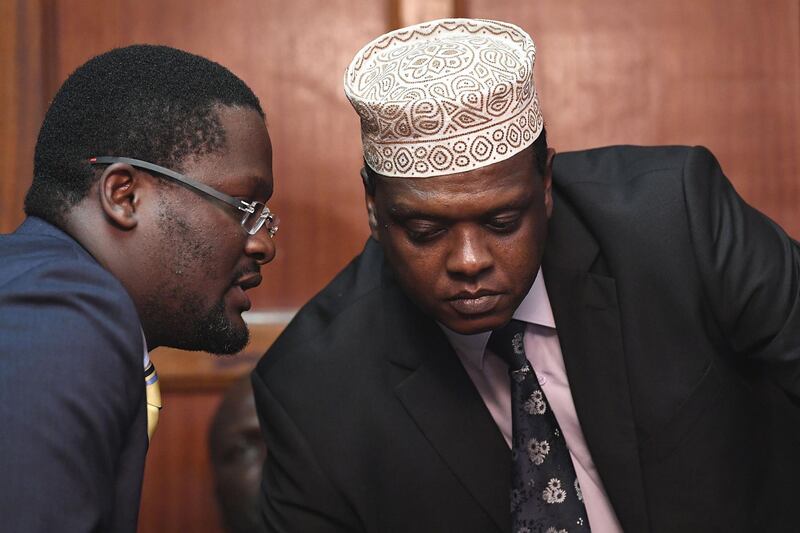 Kenya's Ambassador to Austria and former Sports minister Hassan Wario, right, listens to his lawyer Rogers Sagana in the dock at the Mililani Court in Nairobi. Simon Maina / AFP