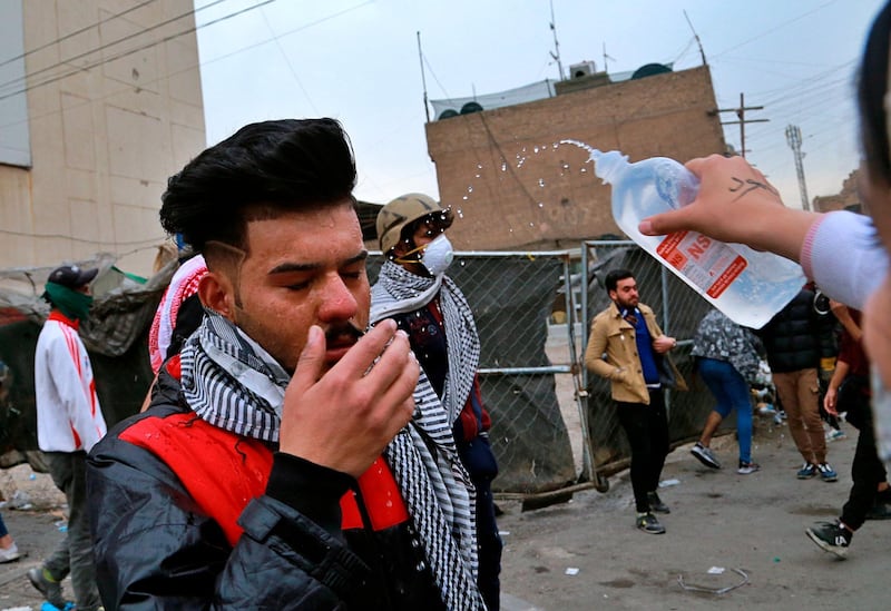 A protester affected by teargas receives first aid during clashes between security forces and anti-government protesters in central Baghdad. AP Photo