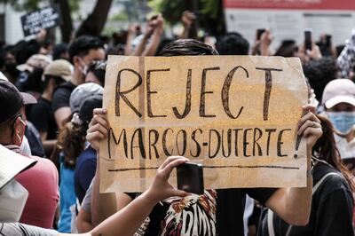 A protester holds a sign outside the Commission of Elections office in Manila, Philippines, on Tuesday. Bloomberg