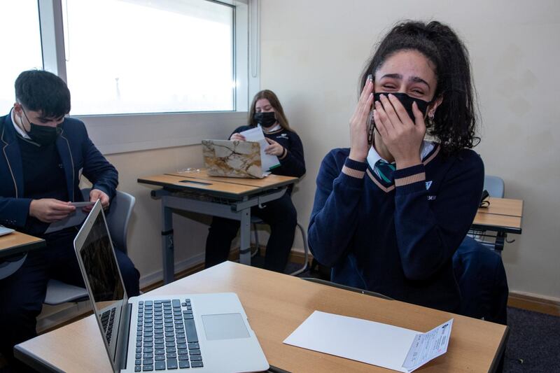 Abu Dhabi, United Arab Emirates, March 3, 2021.  Pupils receive some of their IGCSE and International A-level results for January session 2021. Pupils celebrating after recieving receiving results.  Farah Nour, Grade 9 calls up her mother.
Victor Besa / The National
Section:  NA
Reporter:  Anam Rizvi