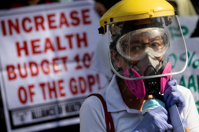 A health worker joins a protest calling for better government response amid the coronavirus outbreak, as the one-year anniversary of the first COVID-19 case in the Philippines approaches, outside a government hospital in Quezon City, Metro Manila, Philippines. Reuters