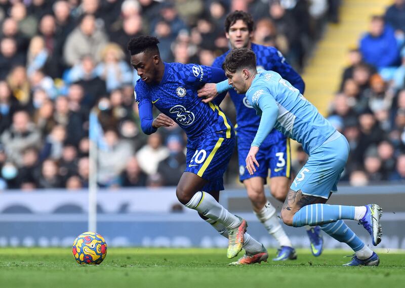 Chelsea winger Callum Hudson-Odoi attempts to take the ball clear Manchester City defender John Stones. Reuters