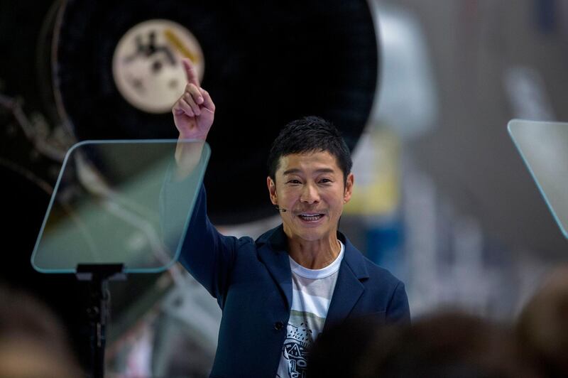 Japanese billionaire Yusaku Maezawa reacts near a Falcon 9 rocket during the announcement by Elon Musk to be the first private passenger who will fly around the Moon aboard the SpaceX BFR launch vehicle, at the SpaceX headquarters and rocket factory on September 17, 2018 in Hawthorne, California. Japanese billionaire businessman, online fashion tycoon and art collector Yusaku Maezawa was revealed as the first tourist who will fly on a SpaceX rocket around the Moon. / AFP / DAVID MCNEW
