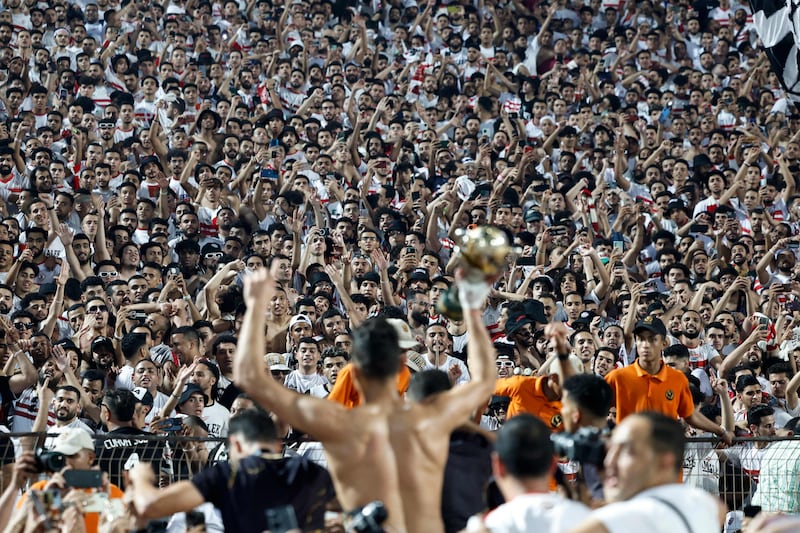 Zamalek's players celebrate with fans after their win at the Cairo International Stadium. AFP
