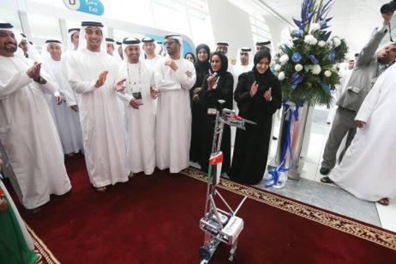 A robot built by female Khalifa University students cut the ribbon for Expo Science International, as Sheikh Mansour bin Zayed, Deputy Prime Minister and Minister for Presidential Affairs, watched on. Fatima Al Marzooqi / The National