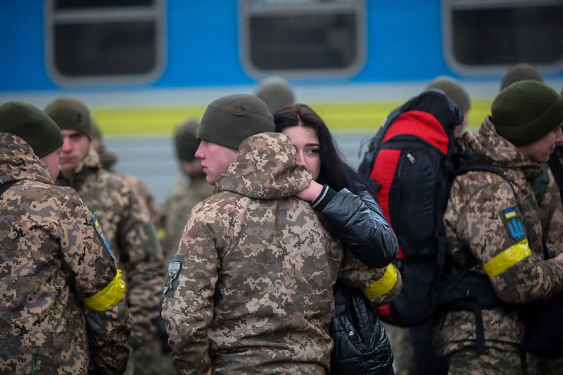 A Ukrainian serviceman says goodbye to his girlfriend before departing in the direction of Kyiv at the central train station in the western Ukrainian city of Lviv. AFP