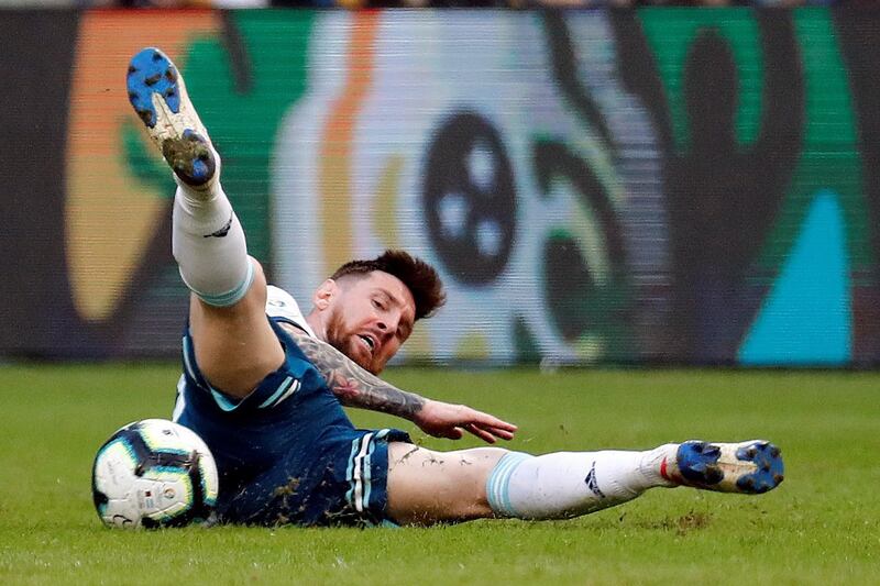 Argentina's Lionel Messi on the ground after a strong challenge from a Qatari defender. EPA