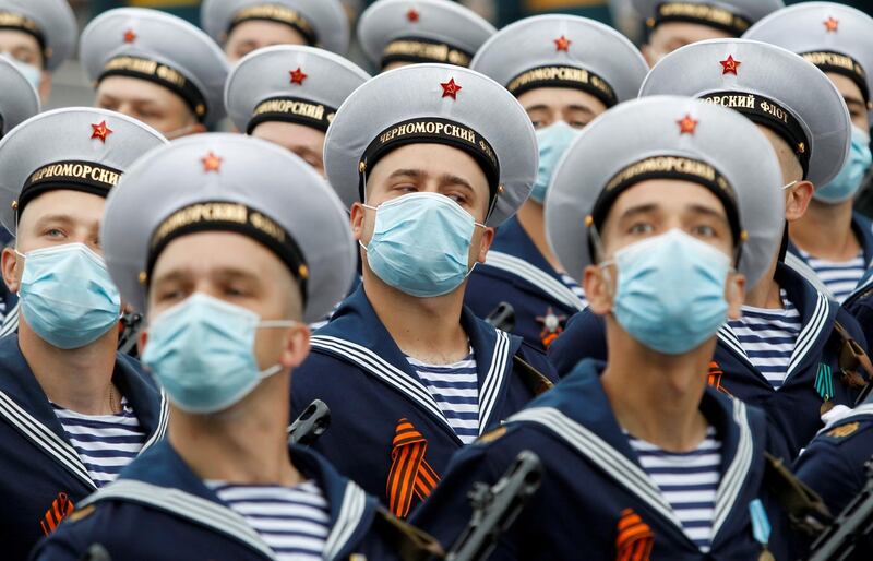 Militants of the self-proclaimed Donetsk People's Republic, wearing protective masks against the coronavirus disease (COVID-19) spread, march during a rehearsal for the Victory Day Parade in Donetsk, Ukraine. REUTERS