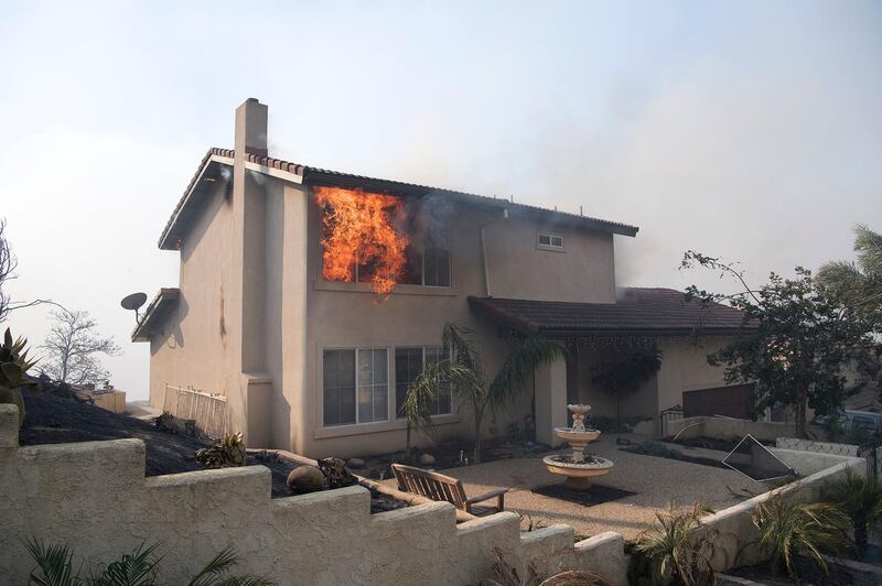 A burning house during the 'Thomas Fire' which began in Ventura, California. In the first 10 hours, the fire burned 45,000 acres (18,200 hectares) and has forced more than 27,000 people to evacuate as one of the strongest Santa Ana winds forecast of the season is ongoing and expected to last several days.  John Cetrino / EPA