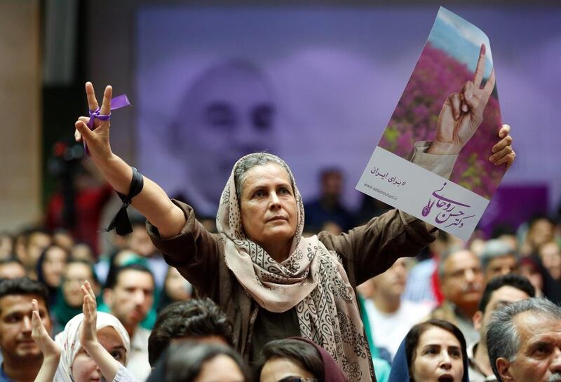 A supporter of Hassan Rouhani flashes victory sign during an election camping rally in Tehran. Abedin Taherkenareh / EPA
