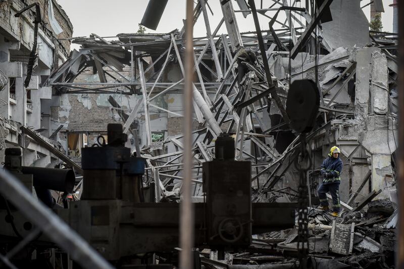 Firefighters dampen down a rail facility in the Darnytsia district of Kyiv after a Russian air strike. EPA