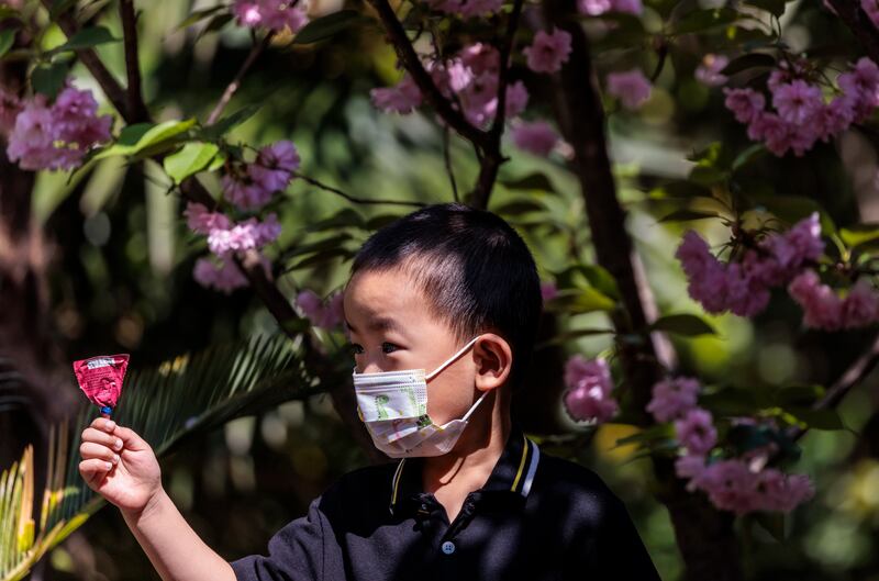 A boy who was in quarantine for 12 days comes outside for a Covid-19 test in Shanghai. EPA
