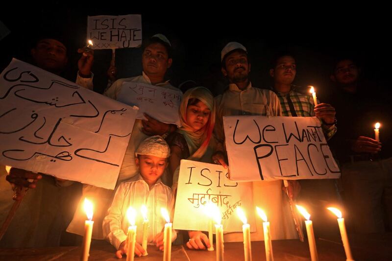 epa08802190 (FILE) - Indian Muslims and children hold candles and slogans against ISIS as they organize a candle light vigil for the victims of the deadly 13 November terrorist attacks in Paris, in Bhopal, India, 15 November 2015 (reissued 06 November 2020). The French capital Paris on 13 November 2020 sees the 5th anniversary of a series of coordinated terrorist attacks in downtown Paris and its northern suburb of Saint-Denis that cost the lives of 131 people and left more than 400 people, partially seriously, injured and traumatized.  EPA/SANJEEV GUPTA *** Local Caption *** 52383253
