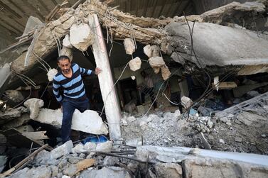 A Palestinian man walks among ruins following Israeli air strikes in Gaza city. The bombing has disrupted water supplies and caused sewage spills. Reuters