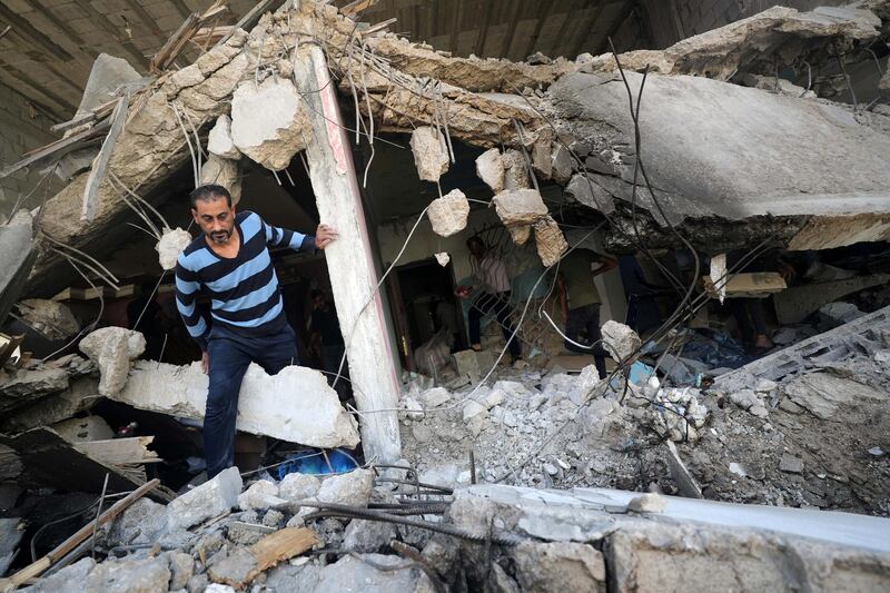 A Palestinian man walks through the ruins in the aftermath of Israeli air strikes, in Gaza City May 17, 2021. REUTERS/Mohammed Salem