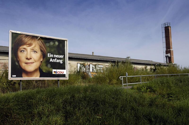 An election poster of Angela Merkel is displayed in front of a factory near Demmin, north east of Germany. September 14, 2005. AFP
