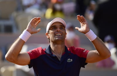 epa09237319 Pablo Andujar of Spain celebrates winning against Dominic Thiem of Austria during their first round match at the French Open tennis tournament at Roland ​Garros in Paris, France, 30 May 2021.  EPA/CAROLINE BLUMBERG