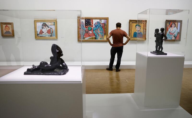 epa08759034 A visitor looks at works of art by French artist Henri Matisse, displayed as part of a retrospective exhibition entitled 'Matisse, like a novel' and held at he Pompidou center in Paris, France, 20 October 2020. The exhibition runs from 21 October to 22 February 2021.  EPA-EFE/IAN LANGSDON