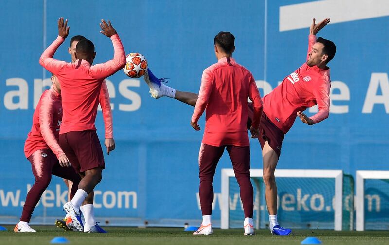 Barcelona midfielder Sergio Busquets, right, stretches for the ball during the training session. Getty Images