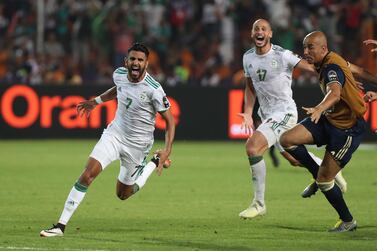 epa07717682 Algeria's Riyad Mahrez (L) celebrates scoring the winning goal with his team during the 2019 Africa Cup of Nations (AFCON) Semi final soccer match between Algeria and Nigeria in Cairo Stadium in Cairo, Egypt, 14 July 2019. EPA/Gavin Barker