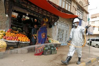 A health worker wearing a protecitve suit disinfects a market amid concerns of the spread of the coronavirus disease (Covid-19), in Sanaa, Yemen. Reuters