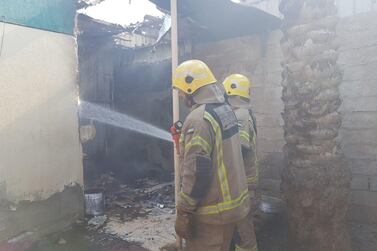 Fire fighters came to the aid of an elderly woman after a fire ripped through her home in Ras Al Khaimah. Courtesy Ras Al Khaimah Civil Defence