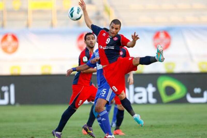 Al Shaab's Rodrigo Souza Silva leaps for the ball against Al Nasr