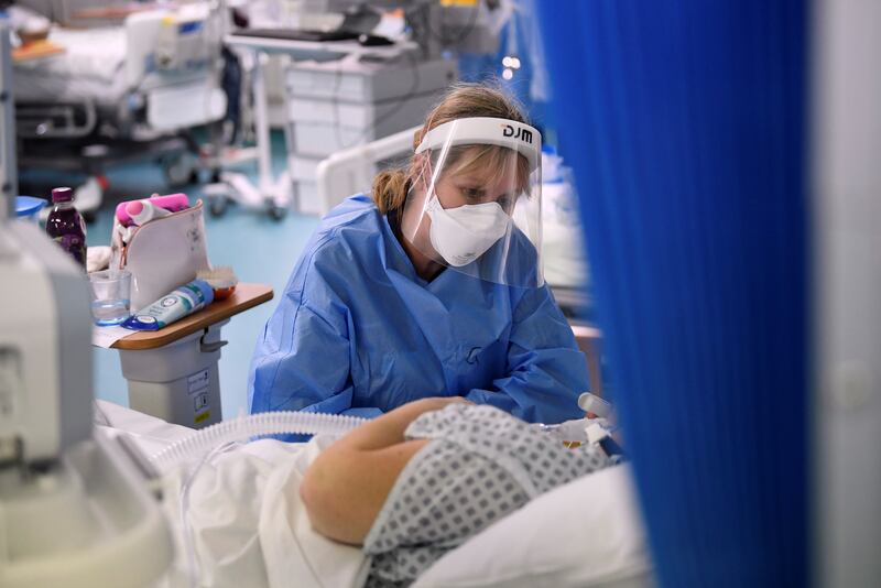 A nurse attends to a patient on a COVID-19 ward at Milton Keynes University Hospital, amid the spread of the coronavirus disease (COVID-19) pandemic, Milton Keynes, Britain, January 20, 2021. Picture taken January 20, 2021. REUTERS/Toby Melville