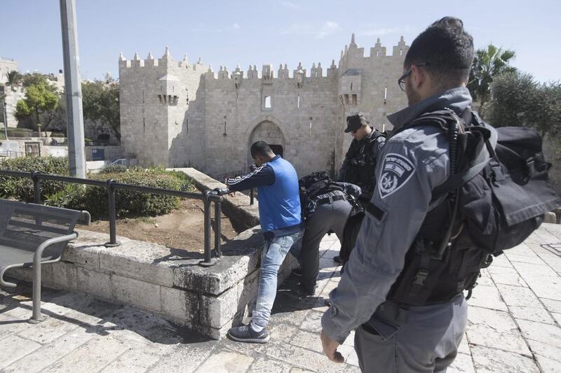 Israeli border police carry out a body search on a Palestinian youth at Damascus Gate, one of the entrances to Jerusalem's Old City, on October 11, 2016. Atef Safadi/EPAI