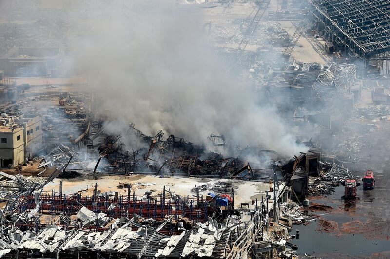 Firefighters extinguish a fire in a warehouse at the port of Beirut. EPA