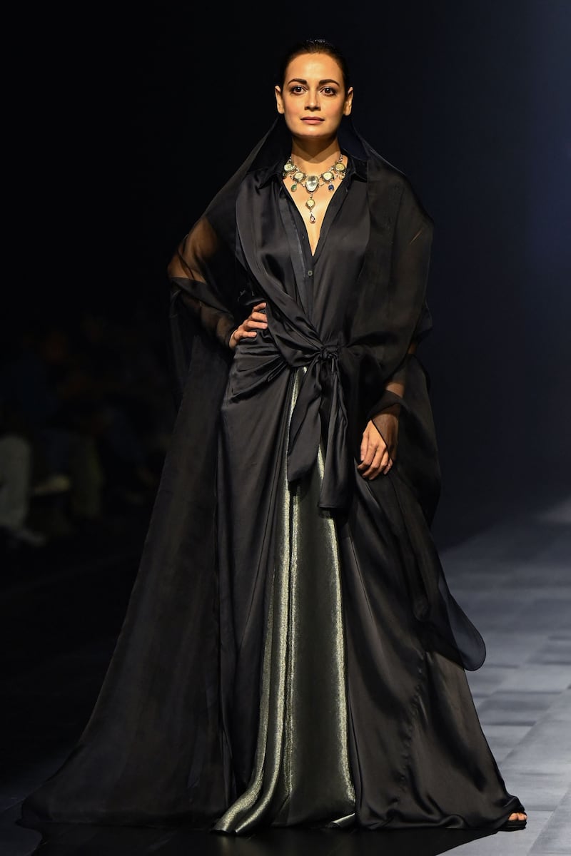 Bollywood actress Dia Mirza presents a creation by designer Amit Hansraj for his label Inca. AFP