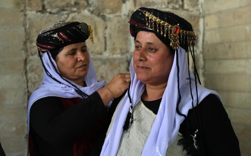Iraqi Yezidi women visit the Temple of Lalish, in a valley near the Kurdish city of Dohuk about 430km northwest of the capital Baghdad, on July 16, 2019. AFP