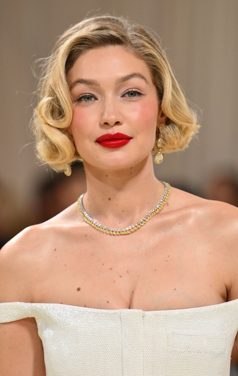 Gigi Hadid in Chopard jewellery with a Thom Browne gown. AFP