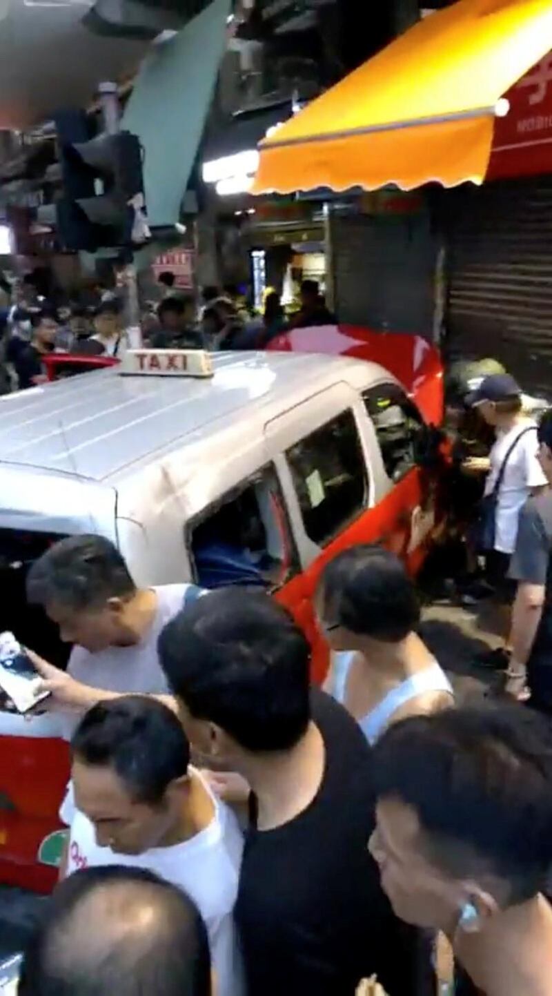 A taxi that ploughed into protesters is seen in the aftermath in Hong Kong. Reuters