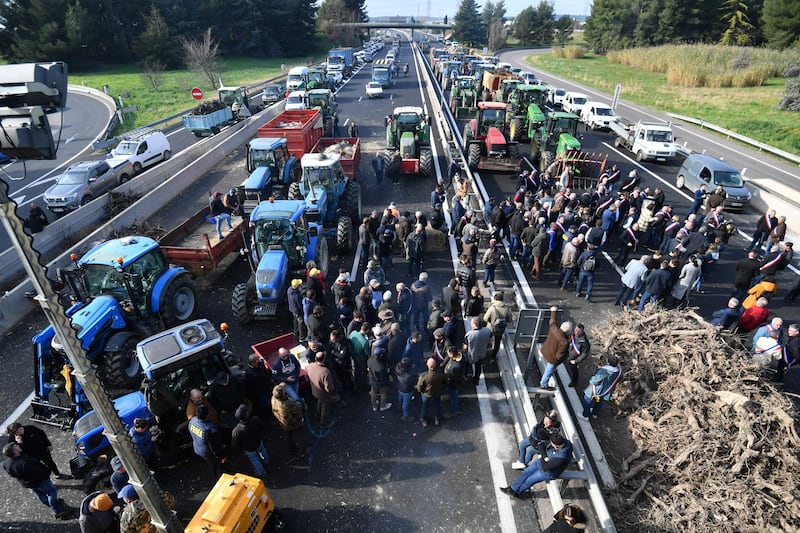 French farmers take part in a road block protest with their tractors on the A9 autoroute (highway) near Nimes, southern France. AFP