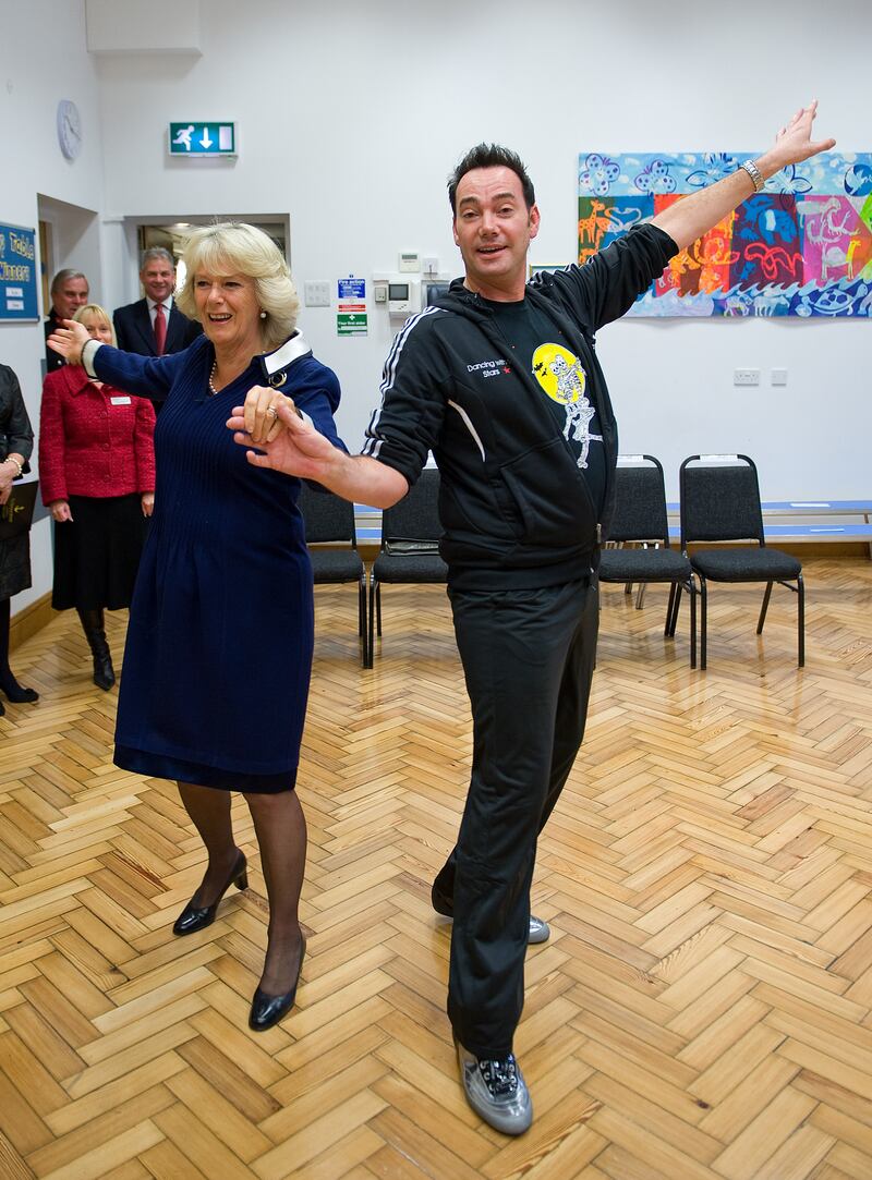 The queen consort dances with Craig Revel Horwood during a visit to St Clement Danes School in London on October 20, 2009. Getty Images