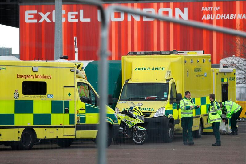 London ambulances in the car park at the ExCel London exhibition centre, which is being turned into a field hospital called NHS Nightingale. AFP