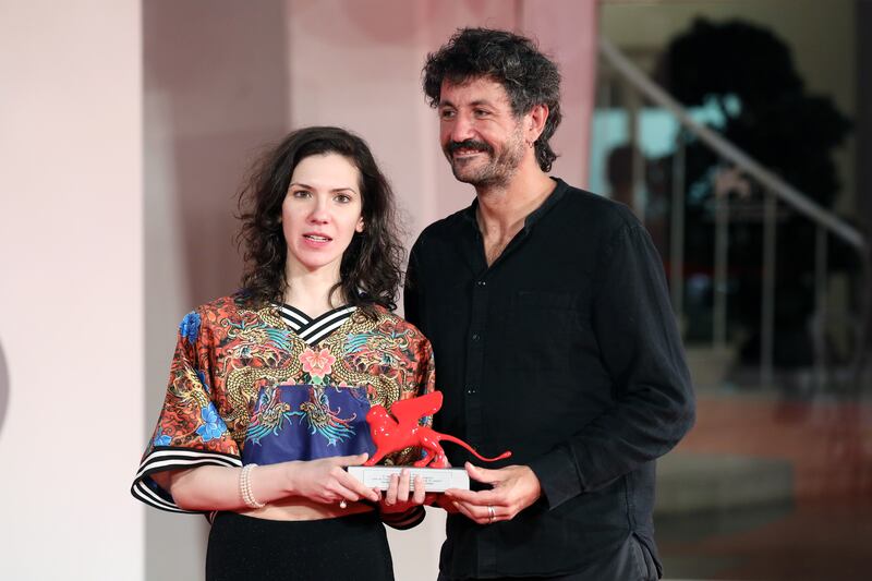 Directors Monica Stan and George Chiper-Lillemark pose with the Lion of the Future Luigi De Laurentiis Venice Award for a Debut Film for 'Imaculat'. Getty Images