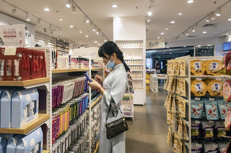 A shopper checks out products inside a Miniso store in Guangzhou, China, on November 19. Bloomberg