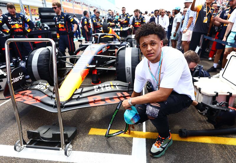 College basketball player Paulo Banchero poses for a photo next to Sergio Perez's Red Bull car ahead of the F1 Grand Prix of Miami. Getty
