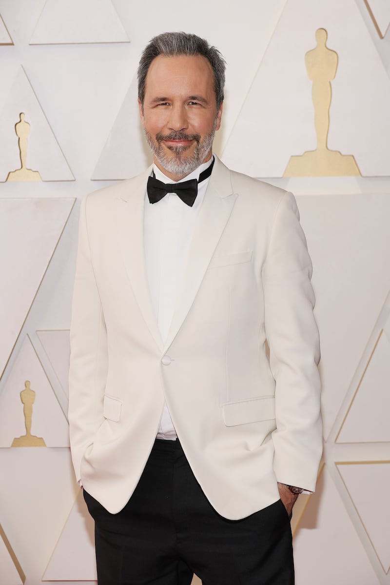 'Dune' director Denis Villeneuve wears a white tuxedo jacket. AFP