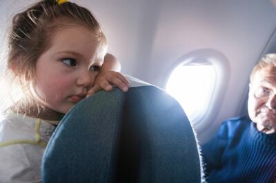 A bored child in the plane. Getty Images