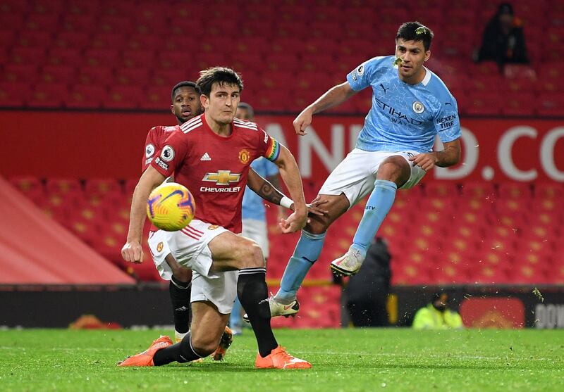 City's Rodrigo shoots at goal as Manchester United's Harry Maguire attempts to block. Reuters