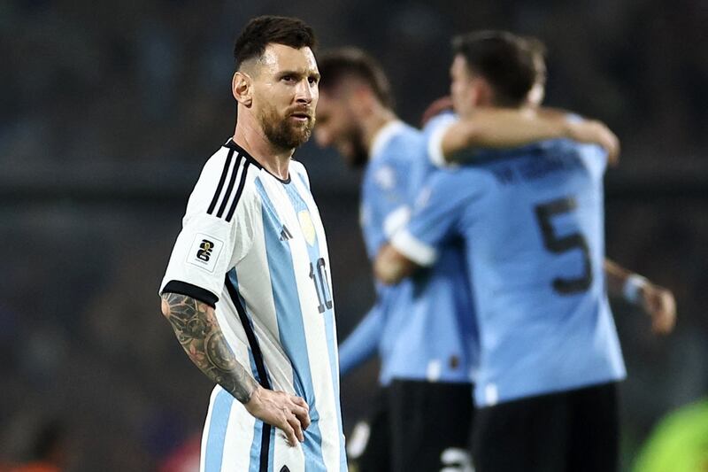 Lionel Messi after the match as Uruguay players celebrate in the background following the 2-0 win over Argentina. Reuters