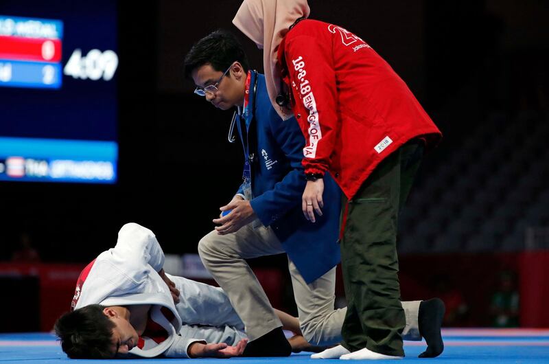 The UAE's Khalid Iskander Al Balushi injures himself during the men’s 56kg final against fellow Emirati Hamad Nawad. Issei Kato / Reuters